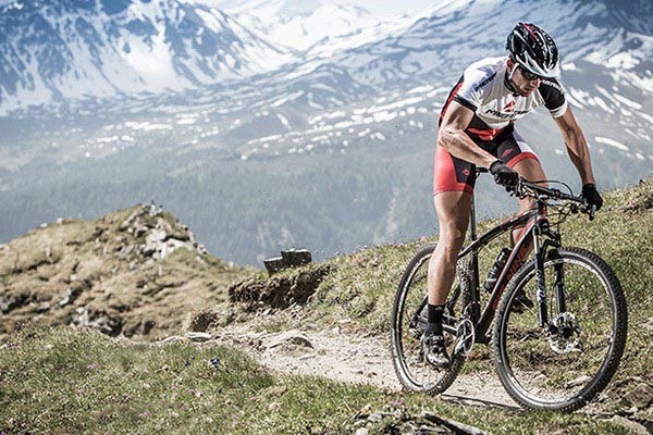 mountainbiker climbing in beautiful terrain