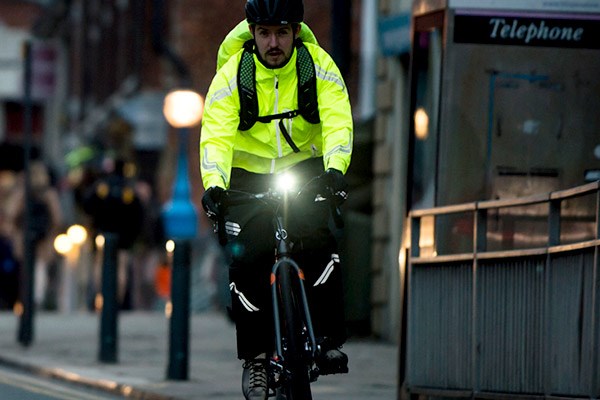 Urban cyclist with a front light and hi-viz clothing