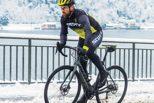 Cyclist wearing thermal bib tights in heavy snow