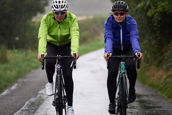 Cyclist in a bent over cycling position wearing a waterproof jacket