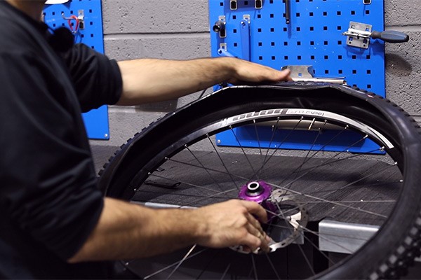 Install one side of tyre into your bike rim