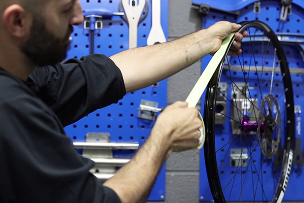 applying tubeless rimn tape to an mtb wheel