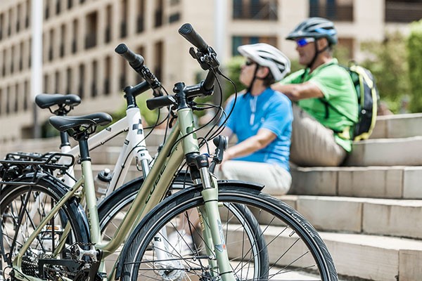 Urban cyclists with a Cube hybrid bike and a Cube step through hybrid bike