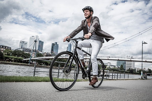 Urban cyclists riding a hybrid bike in a city