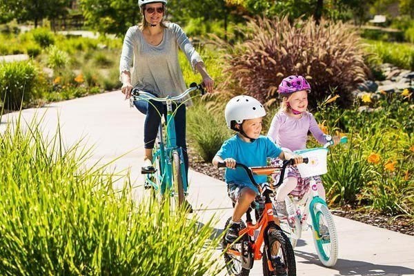 Kids riding a 14 inch and 18 inch kids bike with their family