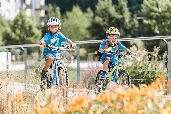 Two 20 inch kids bikes on a cycle path