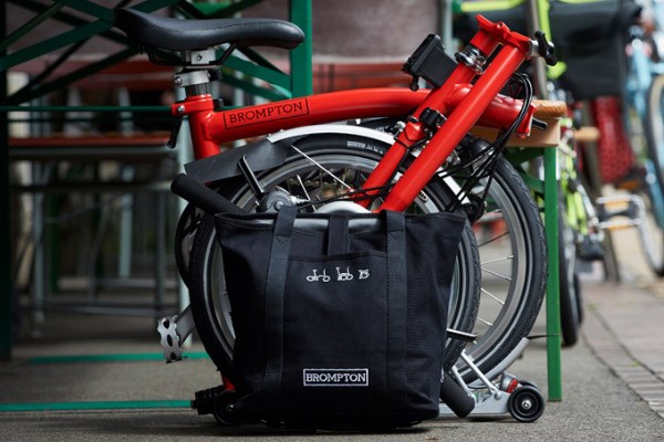 Brompton have a variety of luggage options. Either mounted to the headtube or to a rear luggage rack.