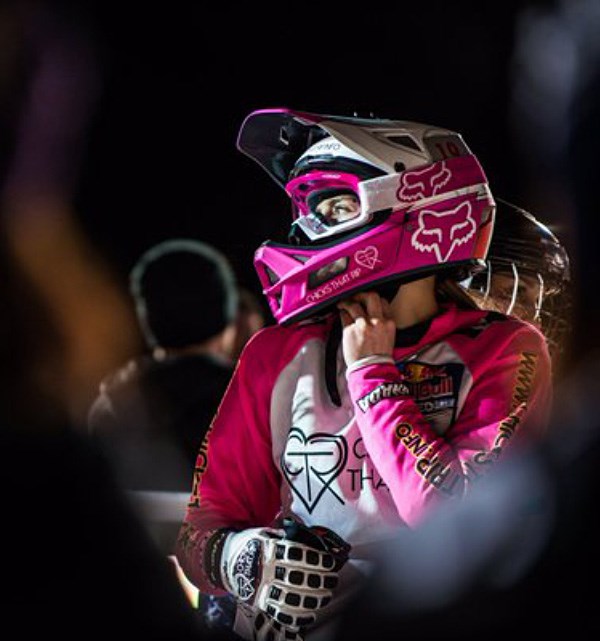 Downhill rider fastening their chin strap