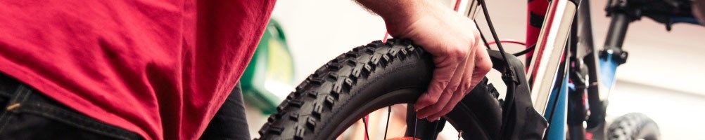 Tredz mechanic checking tyre pressure on a mountain bike