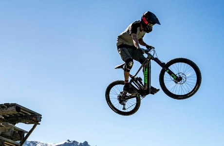 A mountain biker launching a jump on the BMC Trailfox AMP