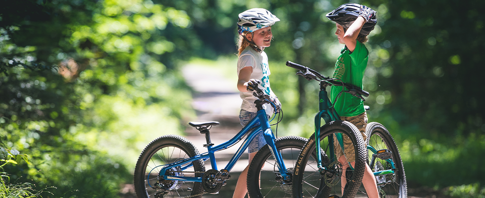 Two kids standing on a cycle path with Merida Matts Jr bikes