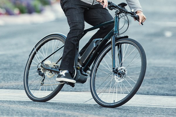 urban cyclist riding an electric bike