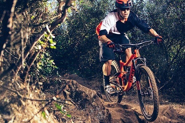 mountain biker riding over rocky ground