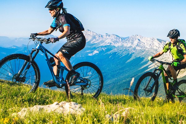 Two cyclists on medium travel full-suspension MTBs