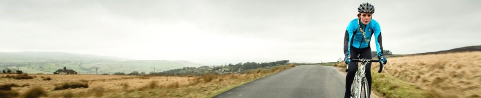 Female cyclist wearing blue cycling jacket