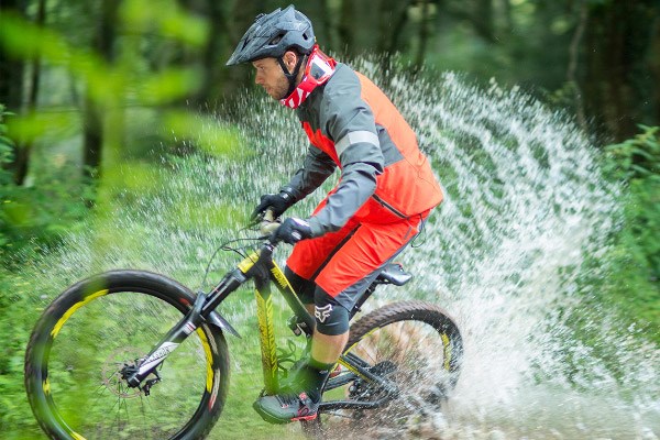 An enduro mountain biker wearing lightweight knee pads