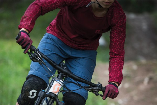 A mountain biker wearing a synthetic long sleeve jersey