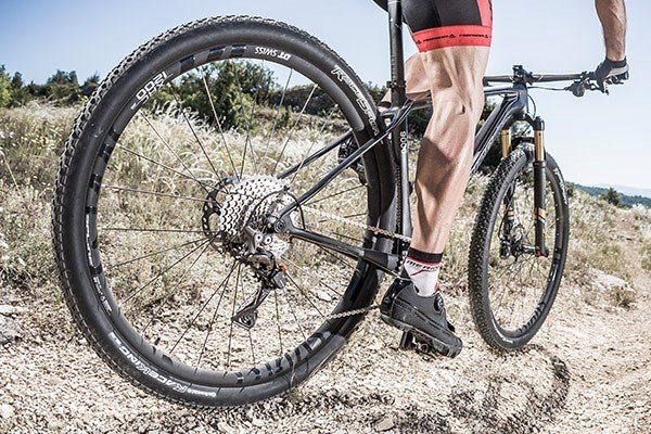 DT Swiss mountain bike wheels wrapped in knobbly tyres