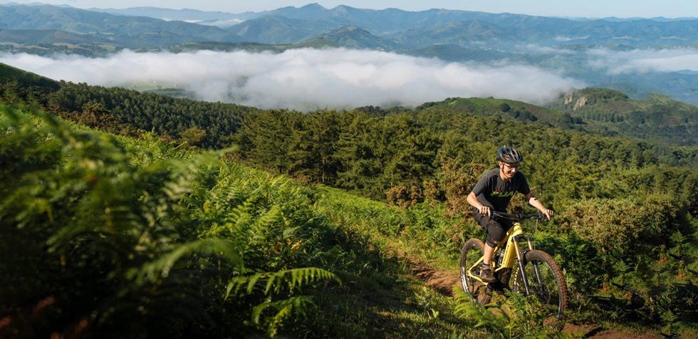 MTB rider climbing on Orbea Wild FS in Spain