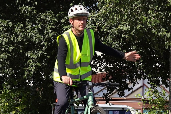 Cyclist using a left turn signal