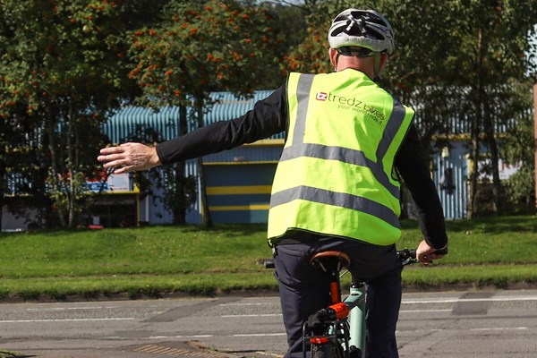 Cyclist signalling a left turn