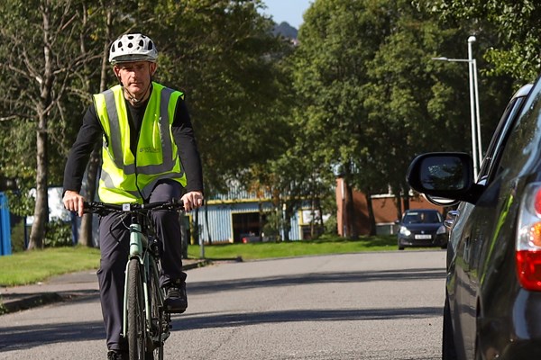 Cyclist passing a parked car