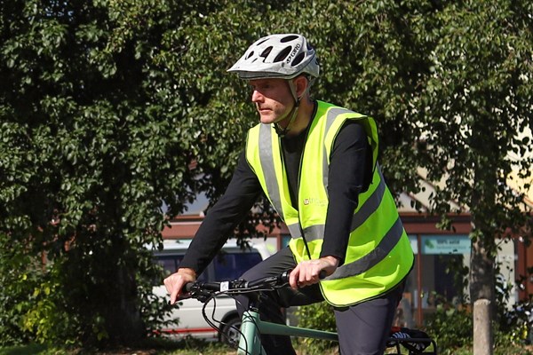 Cyclist riding along on a sunny day