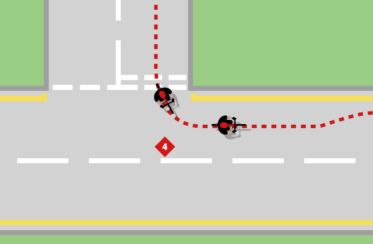 A cyclist turning left onto a main road