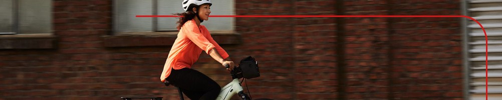 A commuter rides to work on an Electric Liv Hybrid Bike