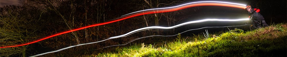 MTB rider with helmet and handlebar light trails