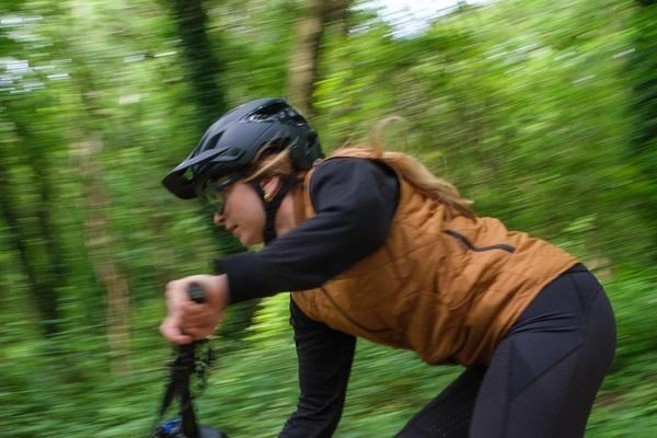Female mountain biker riding fast in Troy Lee Designs kit