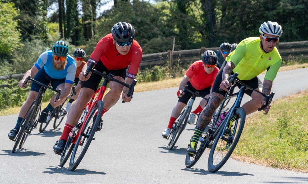 two gravel riders raiding fast on a warm day in Wales - pan shot