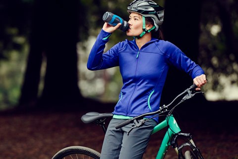 Female rider drinking water