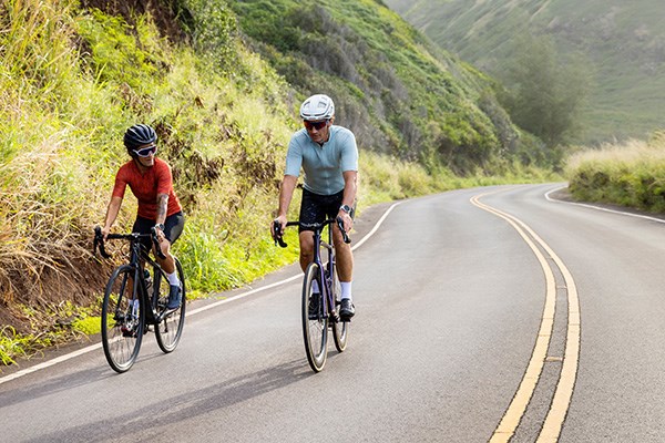 two cyclist riding the open road using a garmin