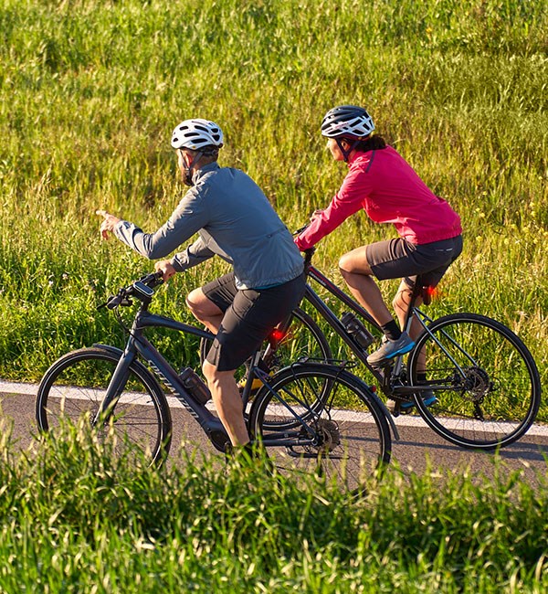 two cyclists using the garmin edge explore 2 to navigate