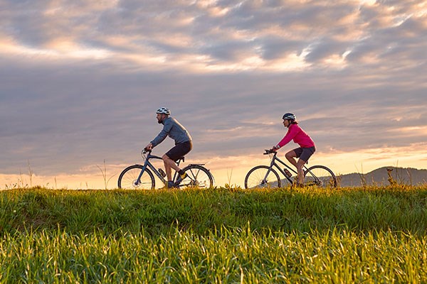 two cyclists riding and navigating with garmin