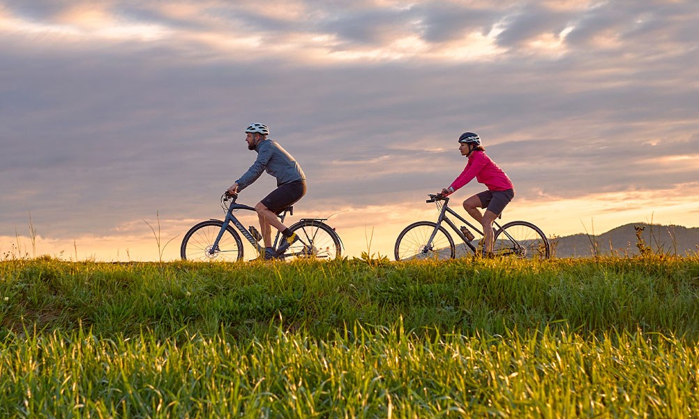 two cyclists riding and navigating with garmin