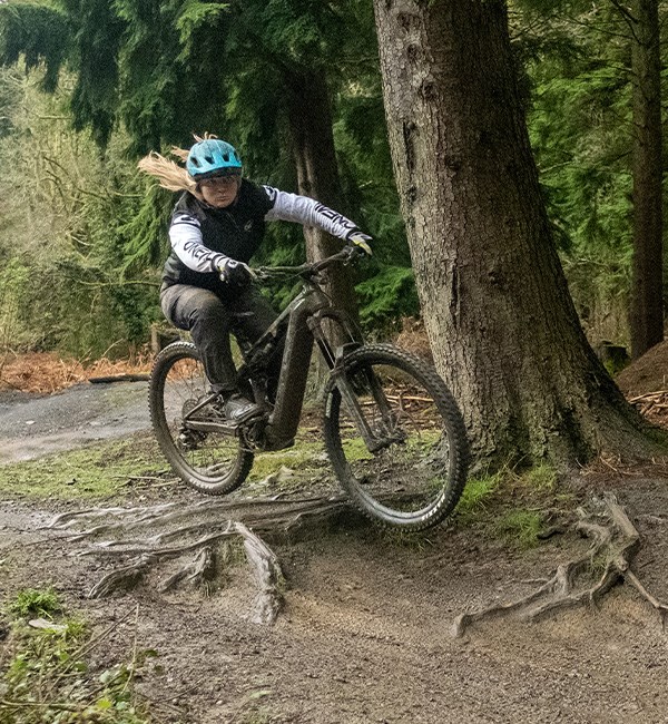 woman riding emtb on technical terrain