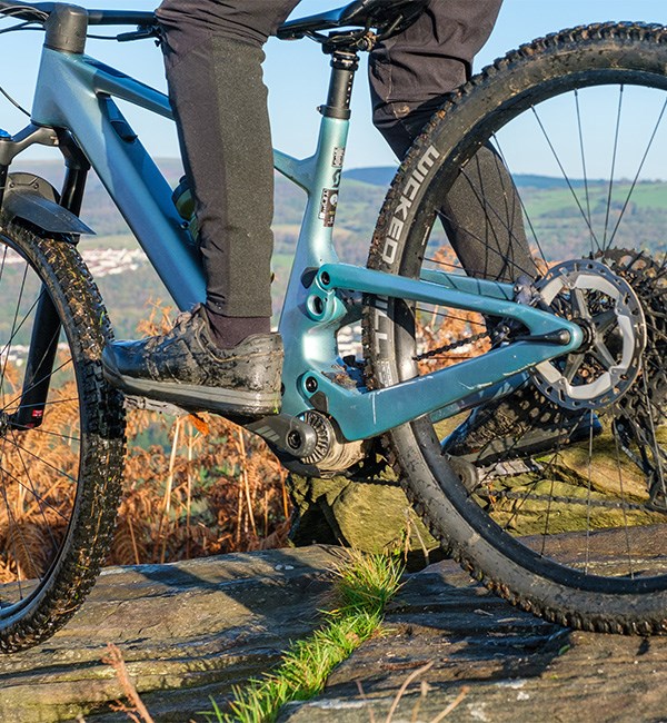 Detail riding shot of the Scott Lumen eRide showing the compact TQ motor