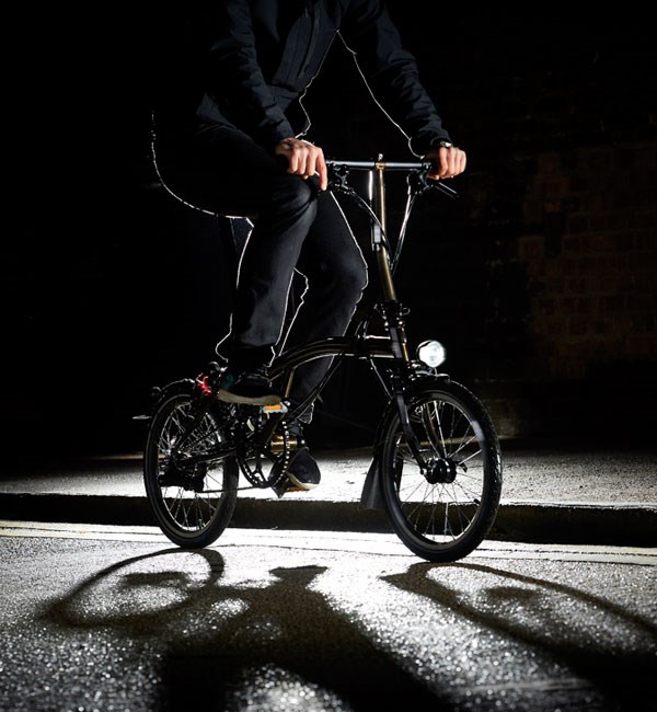 Riding a Brompton Folding bike on a dark city street