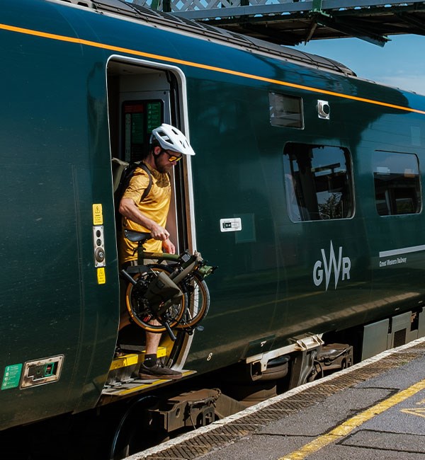 Getting off a train with a Brompton folding bike and Bear Grylls luggage