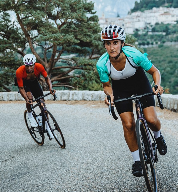 Two riders climbing on Specialized Aethos road bikes