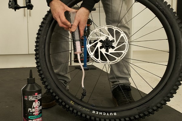 Adding sealant to a tubeless mountain bike tyre and wheel