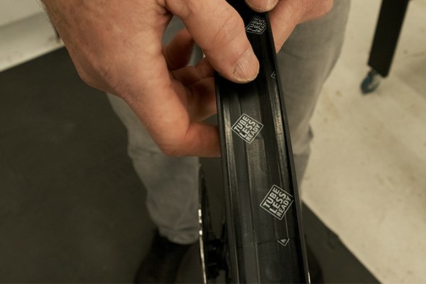 Checking tubeless rim tape on a mountain bike wheel