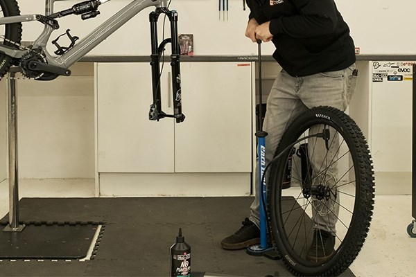 pumping up a mountain bike tyre