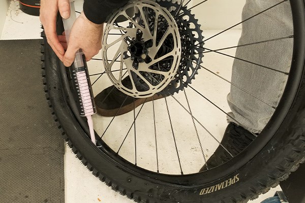 Adding sealant to a tubeless mountain bike tyre