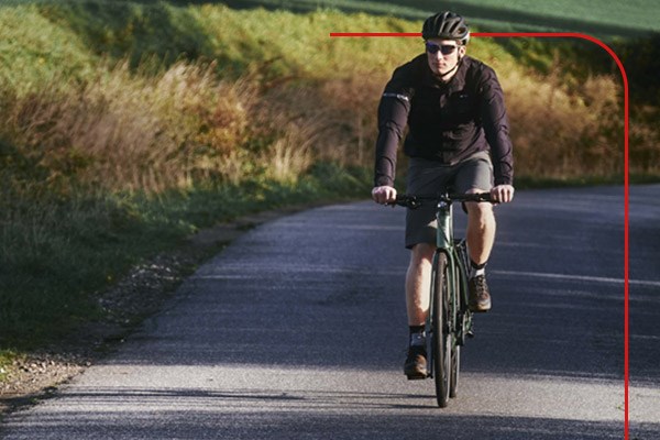 Hybrid cyclist riding in rural area