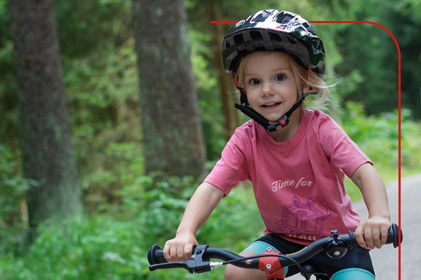 A child cycling with her family