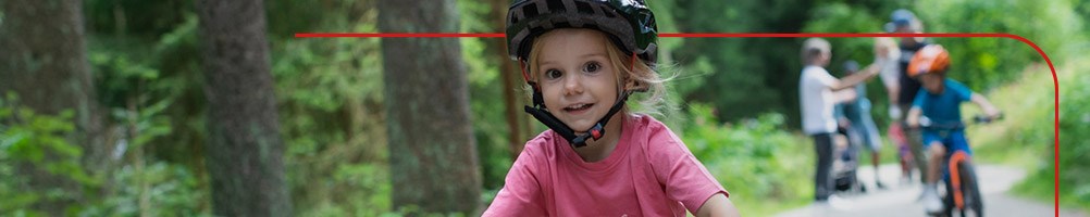 A child cycling with her family