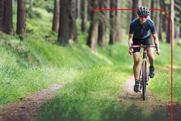 Female cyclist in forest setting